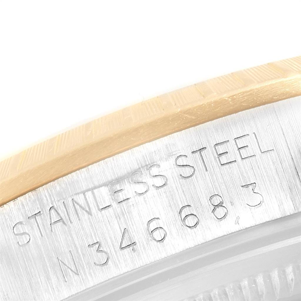 This image shows an angled close-up of the stainless steel engraving and part of the bezel on a Rolex Date 15223 Men's Steel and Gold (two tone) Silver Dial 15223 Men's Steel and Gold (two tone) Silver Dial model watch.