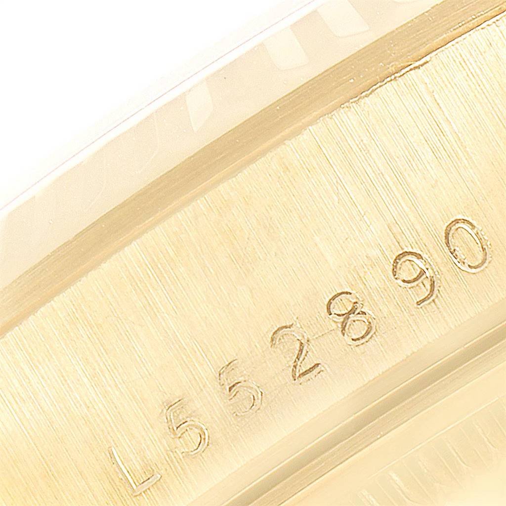 The image shows a close-up angle of the serial number engraved on the case of a Rolex Date 15238 Men's Yellow Gold White Dial 15238 Men's Yellow Gold White Dial model watch.