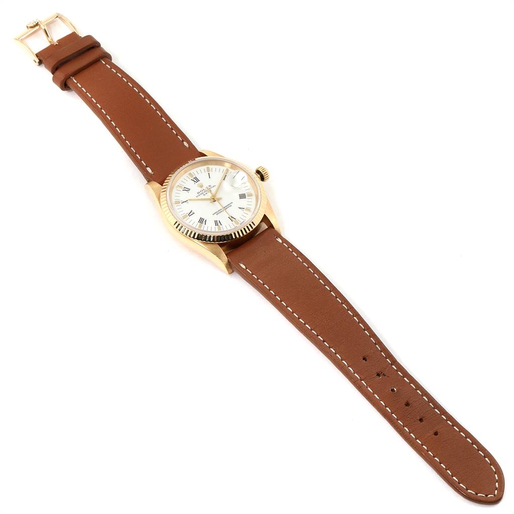 The image shows a Rolex Date 15238 Men's Yellow Gold White Dial 15238 Men's Yellow Gold White Dial model watch with a brown leather strap, gold case, and white dial, viewed from above.