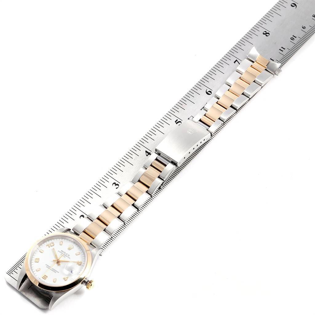 The Rolex Date 15203 Men's Steel and Gold (two tone) White Dial 15203 Men's Steel and Gold (two tone) White Dial model watch is shown from a top-down angle, highlighting the face, band, and clasp.