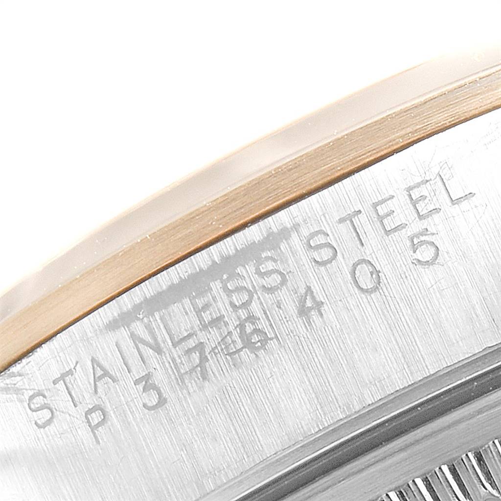 This close-up image shows the caseback of the Rolex Date 15203 Men's Steel and Gold (two tone) White Dial 15203 Men's Steel and Gold (two tone) White Dial model watch, highlighting the "STAINLESS STEEL" engraving.