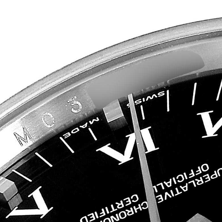 This image shows a close-up, angled view of the dial, bezel, and part of the Rolex Date 115200 Men's Stainless Steel Black Dial 115200 Men's Stainless Steel Black Dial model watch.