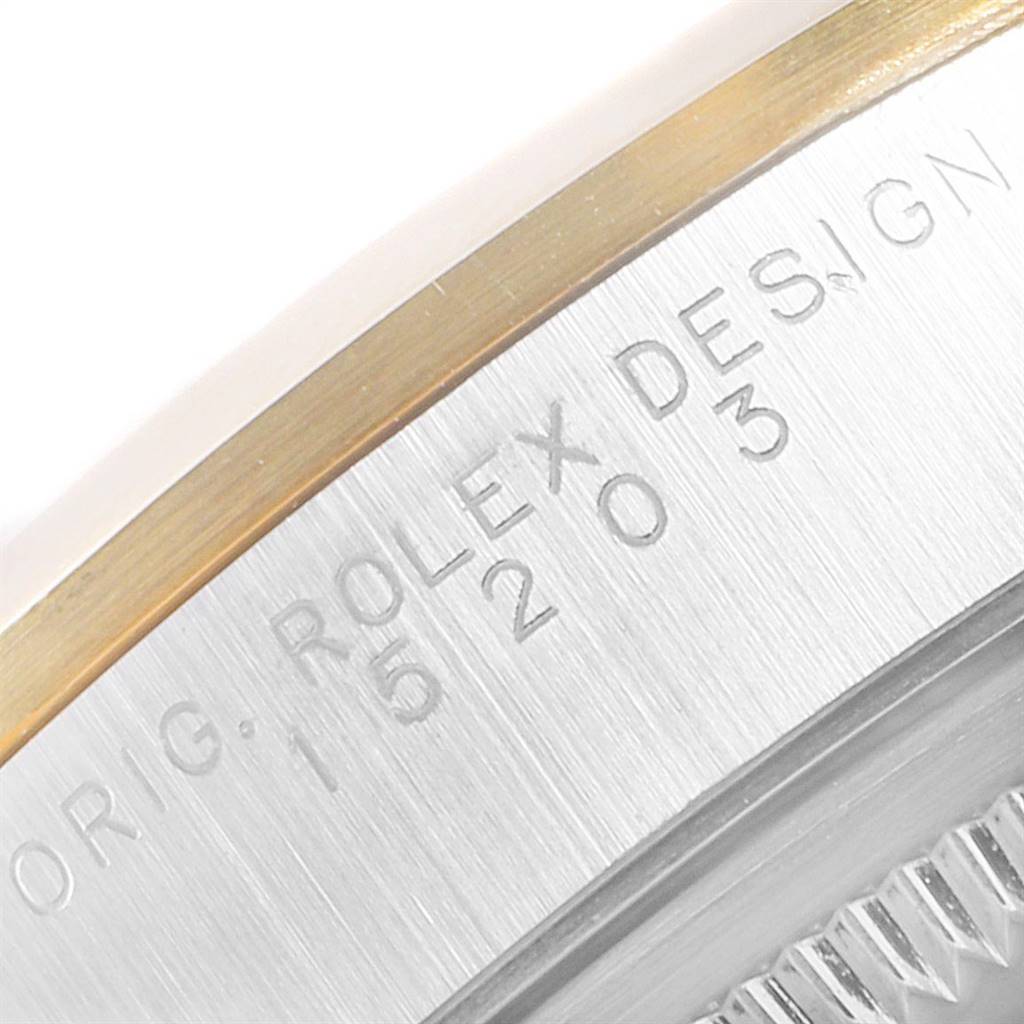 This image shows a close-up of the side of a Rolex Date 15203 Men's Steel and Gold (two tone) White Dial 15203 Men's Steel and Gold (two tone) White Dial model, highlighting the engraved details on its casing.