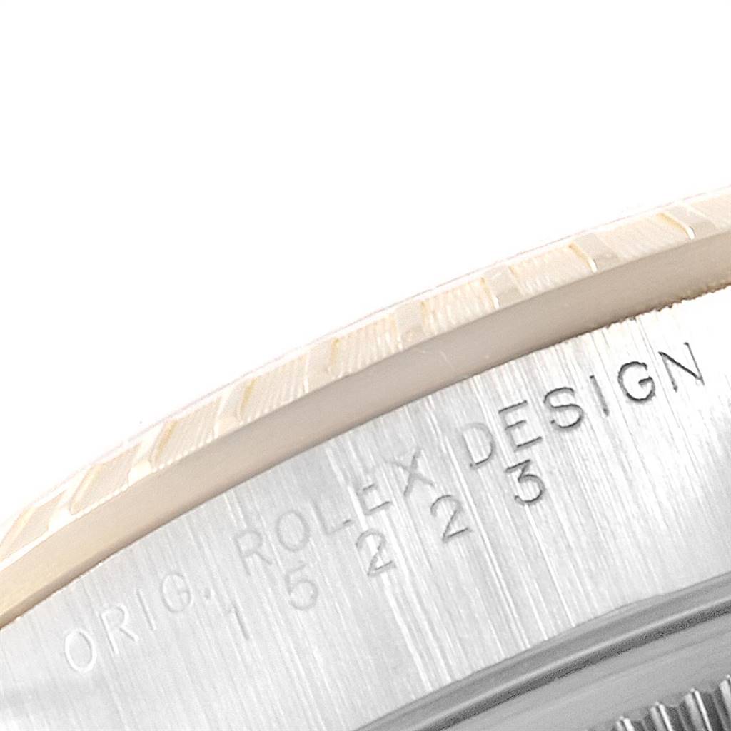 The image shows a close-up of the casing with engraved markings of a Rolex Date 15223 Men's Steel and Gold (two tone) White Dial 15223 Men's Steel and Gold (two tone) White Dial model watch.