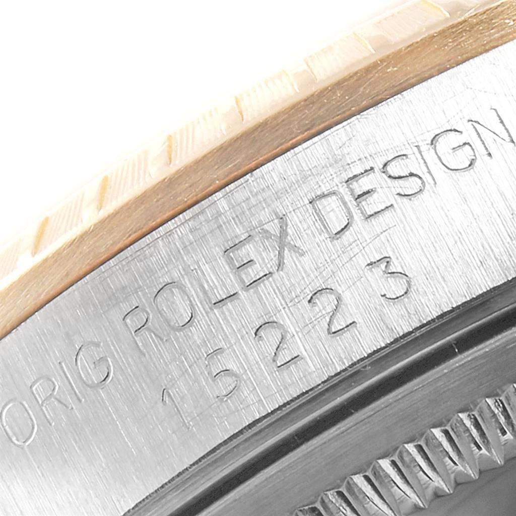 This image shows a close-up of the bezel and case edge of a Rolex Date 15223 Men's Steel and Gold (two tone) White Dial 15223 Men's Steel and Gold (two tone) White Dial model watch, including the engraved model number.