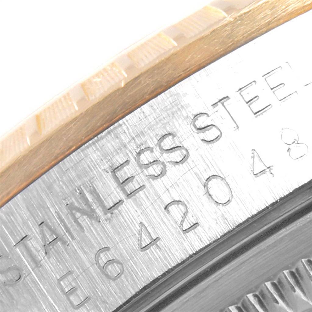 The image shows a close-up of the engraved stainless steel case and fluted bezel of the Rolex Date 15223 Men's Steel and Gold (two tone) White Dial 15223 Men's Steel and Gold (two tone) White Dial watch.