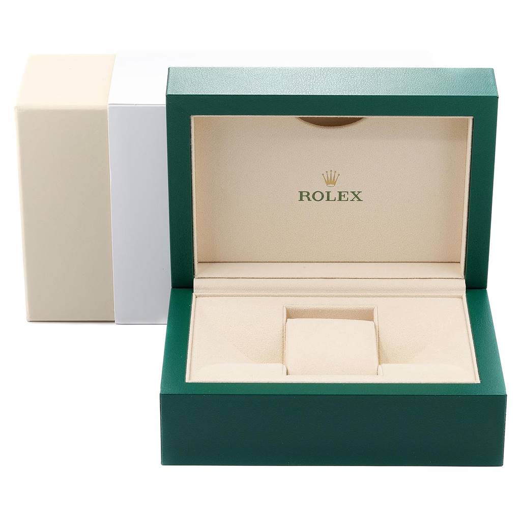 This image shows an open green and beige Rolex watch box, with the lid up and the insert visible.