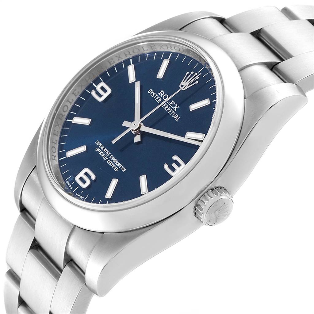 This image shows a side angle of a Rolex Date 116000 Men's Stainless Steel Blue Dial 116000 Men's Stainless Steel Blue Dial model watch, featuring its face, bezel, crown, and part of the bracelet.