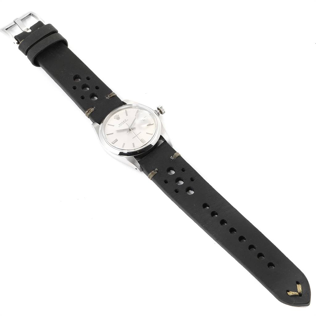 The image shows a top-down view of a Rolex Date 6694 Men's Stainless Steel Silver Dial 6694 Men's Stainless Steel Silver Dial model watch with a black perforated leather strap.