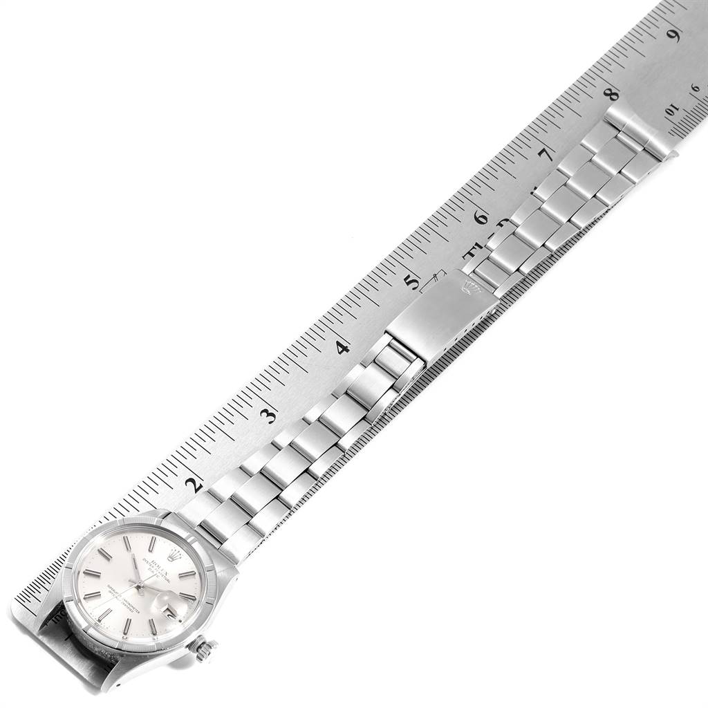 The image shows a Rolex Date 1501 Men's Stainless Steel Silver Dial 1501 Men's Stainless Steel Silver Dial model watch and its metal bracelet laid flat against a ruler for measurement.