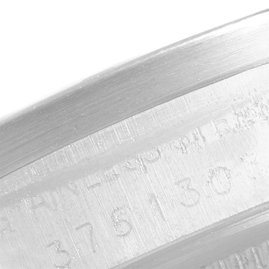 This close-up image shows the engraved serial number on the bezel of a Rolex Date 1501 Men's Stainless Steel Silver Dial 1501 Men's Stainless Steel Silver Dial model watch.