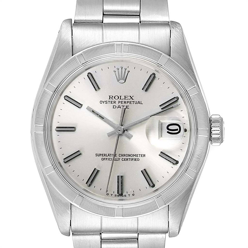The image shows a front view of a Rolex Oyster Perpetual Date, displaying the dial, hands, crown, and part of the bracelet.