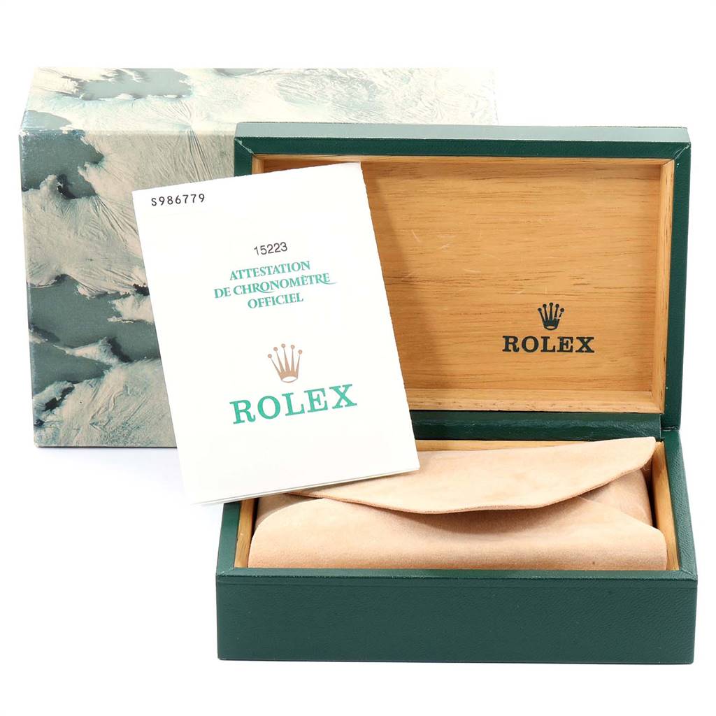 The image shows the packaging and certificate for the Rolex Date 15223 Men's Steel and Gold (two tone) White Dial 15223 Men's Steel and Gold (two tone) White Dial model, including a green and wooden box and an official certificate.