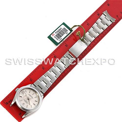 This image shows a top-down view of a Rolex Date 15200 Men's Stainless Steel Silver Dial 15200 Men's Stainless Steel Silver Dial model watch, including its face, stainless steel bracelet, and clasp, alongside a red measuring ruler.