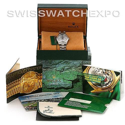 The Rolex Date 15200 Men's Stainless Steel Silver Dial 15200 Men's Stainless Steel Silver Dial model watch is shown in its open box at a front angle, with various booklets and a cleaning cloth displayed around it.