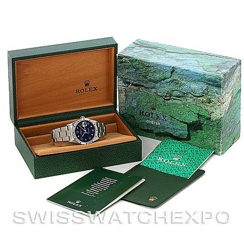 This image shows a Rolex Date 15210 Men's Stainless Steel Blue Dial 15210 Men's Stainless Steel Blue Dial watch in its open case along with its outer box and accompanying manuals and booklets.