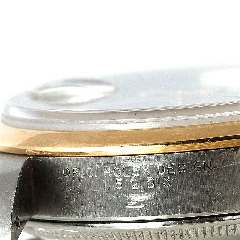 This close-up image of a Rolex Date 15203 Men's Steel and Gold (two tone) Grey Dial 15203 Men's Steel and Gold (two tone) Grey Dial model watch shows the side casing with the model number 15203 engraved.