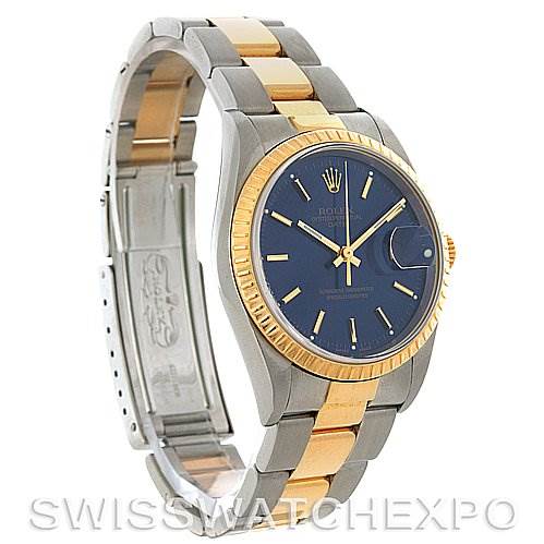 The image shows a Rolex Date 15223 Men's Steel and Gold (two tone) Blue Dial 15223 Men's Steel and Gold (two tone) Blue Dial model watch at a slight angle, highlighting the blue dial, gold fluted bezel, bracelet, and the clasp.