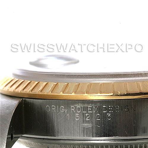 The image shows a side and partial bottom view of a Rolex Date 15223 Men's Steel and Gold (two tone) Blue Dial 15223 Men's Steel and Gold (two tone) Blue Dial model watch, focusing on the bezel and case with engraving.