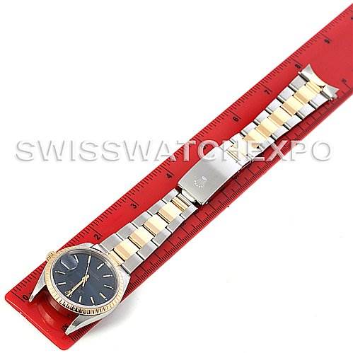 The image shows a top-down view of a Rolex Date 15223 Men's Steel and Gold (two tone) Blue Dial 15223 Men's Steel and Gold (two tone) Blue Dial model watch placed on a measuring scale displaying its full length.