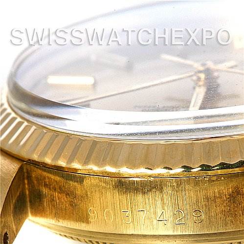 Close-up side view of the Rolex Date 15037 Men's Yellow Gold Champagne Dial 15037 Men's Yellow Gold Champagne Dial watch, showing the bezel, partially the dial, and the case with a visible serial number.