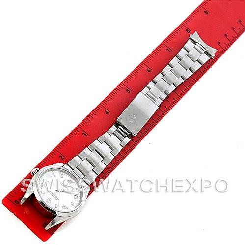 The Rolex Date 15200 Men's Stainless Steel White Dial 15200 Men's Stainless Steel White Dial model watch is shown from the top with its bracelet fully extended next to a red ruler.