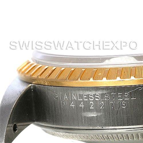The image shows a close-up of the side of a Rolex Date 15223 Men's Steel and Gold (two tone) Grey Dial 15223 Men's Steel and Gold (two tone) Grey Dial model watch, highlighting its bezel and case with engraving.