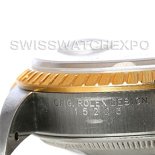 The image shows a close-up side angle of the Rolex Date 15223 Men's Steel and Gold (two tone) Grey Dial 15223 Men's Steel and Gold (two tone) Grey Dial model, highlighting the bezel and part of the case with engravings.