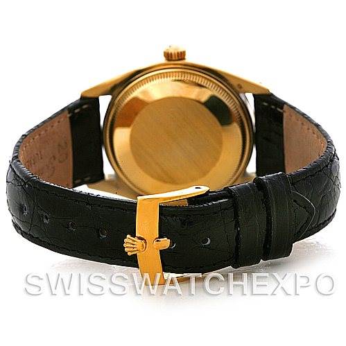 This image shows the back view of a Rolex Date 1503 Men's Yellow Gold Black Dial 1503 Men's Yellow Gold Black Dial model, including the case, crown, and black leather strap with a gold buckle.