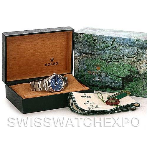 The image shows a Rolex Date 15200 Men's Stainless Steel Blue Dial 15200 Men's Stainless Steel Blue Dial model watch, its box, warranty card, and accessories from a front angle.