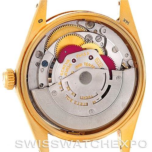 The image shows the back view of a Rolex Date 1503 Men's Yellow Gold Champagne Dial 1503 Men's Yellow Gold Champagne Dial watch, displaying its intricate automatic movement and internal components.