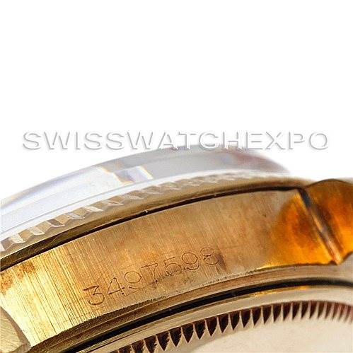 The image shows a close-up of the side of a Rolex Date 1503 Men's Yellow Gold Champagne Dial 1503 Men's Yellow Gold Champagne Dial model watch, highlighting its serial number and part of the bezel.
