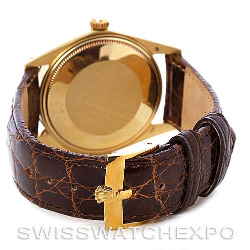 The image shows the back and side of a Rolex Date 1503 Men's Yellow Gold Champagne Dial 1503 Men's Yellow Gold Champagne Dial model watch, highlighting its leather strap and clasp.