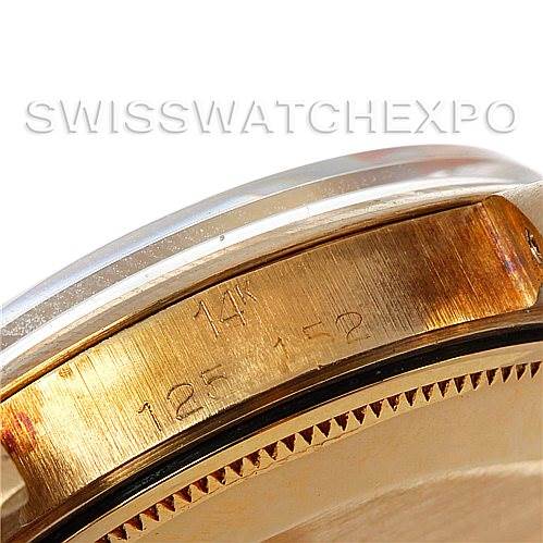 This image shows a close-up of the side profile of a Rolex Date 1503 Men's Yellow Gold Silver Dial 1503 Men's Yellow Gold Silver Dial model by Rolex, highlighting part of the bezel and case with engravings.