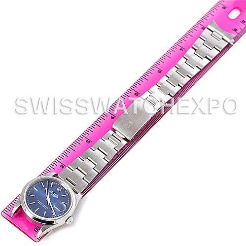 The image shows a Rolex Date 15200 Men's Stainless Steel Blue Dial 15200 Men's Stainless Steel Blue Dial Model watch laid flat next to a pink ruler, displaying its face, bracelet, and clasp.
