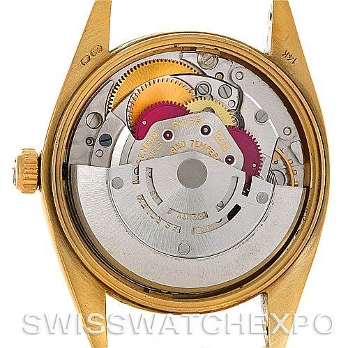 The image shows the internal movement of a Rolex Date 1503 Men's Yellow Gold Silver Dial 1503 Men's Yellow Gold Silver Dial model watch from a back angle, showcasing the gears and rotor.