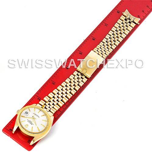 The image shows a Rolex Date 1503 Men's Yellow Gold Silver Dial 1503 Men's Yellow Gold Silver Dial model watch laid flat on a ruler, displaying its face, case, and metal bracelet.