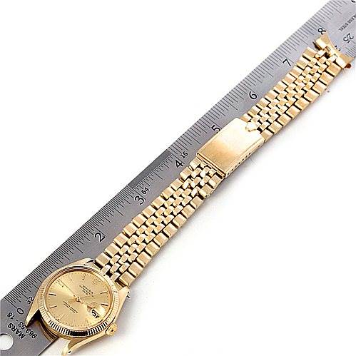 This image shows a Rolex Date 1503 Men's Yellow Gold Champagne Dial 1503 Men's Yellow Gold Champagne Dial model watch laid flat alongside a ruler, displaying its face, bracelet, and clasp from a top-down angle.