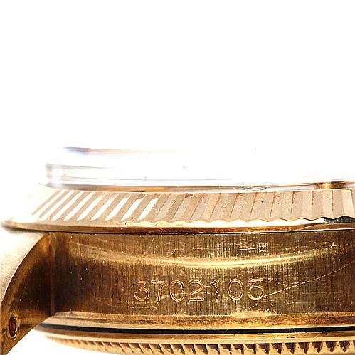 This image shows a side view of the casing and bezel, including the serial number engraving, of a Rolex Date 1503 Men's Yellow Gold Champagne Dial 1503 Men's Yellow Gold Champagne Dial model watch.