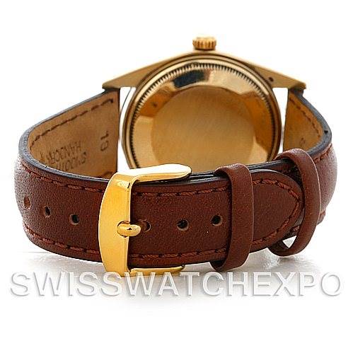 The image shows the rear angle of a Rolex Date 1503 Men's Yellow Gold Champagne Dial 1503 Men's Yellow Gold Champagne Dial model with a brown leather strap and a gold buckle.