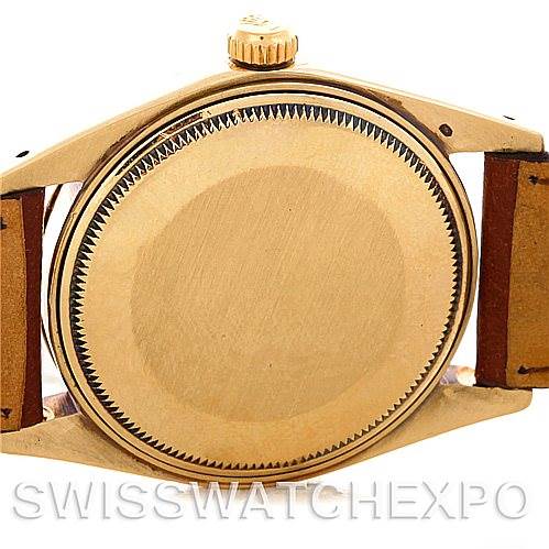 This image shows the back case and crown of a Rolex Date 1503 Men's Yellow Gold Champagne Dial 1503 Men's Yellow Gold Champagne Dial watch, showcasing its gold finishing and brown leather strap.