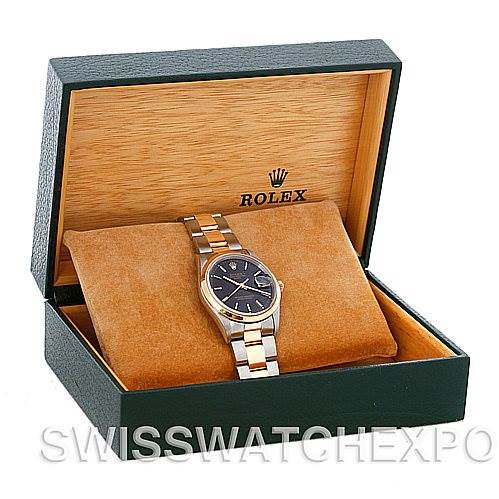 This Rolex Date 15203 Men's Steel and Gold (two tone) Black Dial 15203 Men's Steel and Gold (two tone) Black Dial model watch is shown at an angle inside an open green and beige Rolex box, displaying the dial, bracelet, and case.