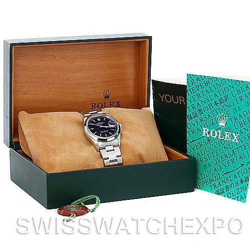 The image shows a Rolex Date 15200 Men's Stainless Steel Black Dial 15200 Men's Stainless Steel Black Dial model watch at an angle, displayed in an open box with booklets and tags beside it.
