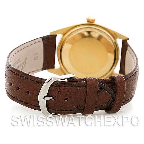 The image shows the back view of a Rolex Date 1503 Men's Yellow Gold Silver Dial 1503 Men's Yellow Gold Silver Dial model watch with a brown leather strap and gold case.