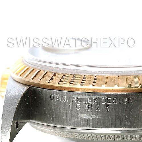 This is a close-up, side view of the case and bezel of a Rolex Date 15223 Men's Steel and Gold (two tone) Champagne Dial 15223 Men's Steel and Gold (two tone) Champagne Dial, showing the "ORIG. ROLEX DESIGN" engraving and the model number.