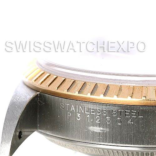 The image shows a close-up of the side of a Rolex Date 15223 Men's Steel and Gold (two tone) Champagne Dial 15223 Men's Steel and Gold (two tone) Champagne Dial model, highlighting the stainless steel case, bezel, and serial number.