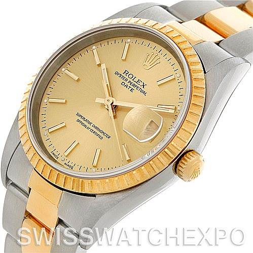 The image shows a Rolex Date 15223 Men's Steel and Gold (two tone) Champagne Dial 15223 Men's Steel and Gold (two tone) Champagne Dial model watch at a tilted angle, displaying the face, crown, and part of the bracelet.