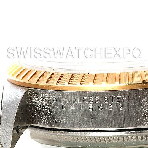 This image shows a close-up of the side view of a Rolex Date 15223 Men's Steel and Gold (two tone) Silver Dial 15223 Men's Steel and Gold (two tone) Silver Dial model, highlighting the serial number and part of the bezel and case.