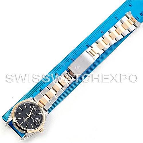This image shows a full view of a Rolex Date 15203 Men's Steel and Gold (two tone) Black Dial 15203 Men's Steel and Gold (two tone) Black Dial model watch, including the dial, bracelet, and clasp, aligned with a blue measurement ruler.