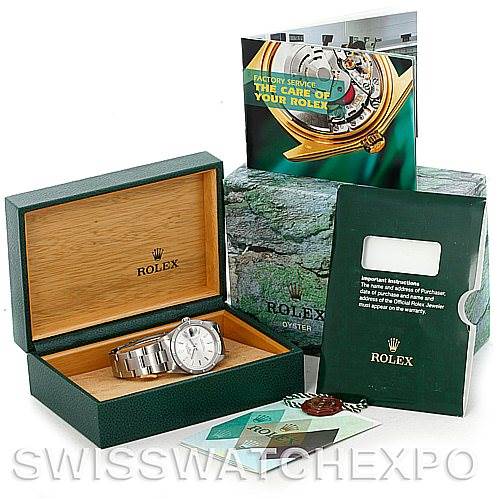 The image shows a Rolex Date 15210 Men's Stainless Steel Silver Dial 15210 Men's Stainless Steel Silver Dial watch in its open box, accompanied by a booklet, certificate holder, and tag from a slightly elevated angle.
